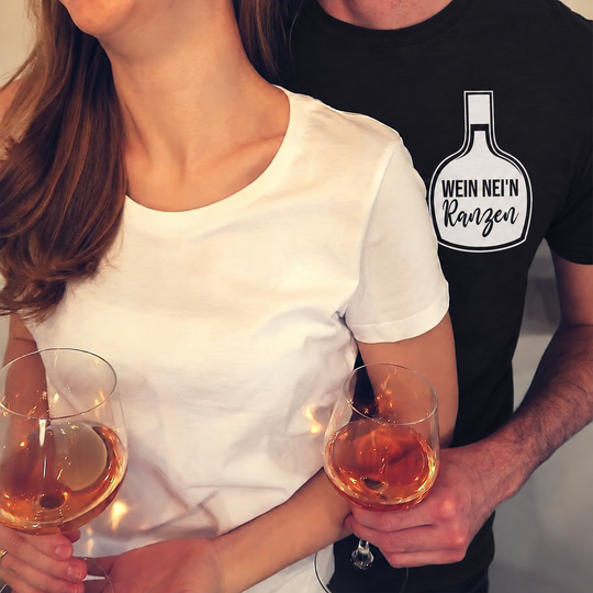 Herren-T-Shirt Schwarz mit Wein nei’n Ranzen; eigene Paaraufnahme digital bearbeitet, Begleiterin mit neutralem weißen Shirt.