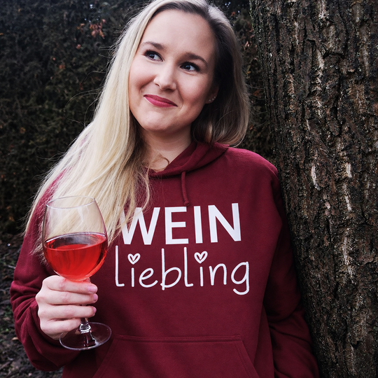 Weinliebling Unisex Hoodie in Bordeaux – bearbeitete Trageansicht mit Weinglas